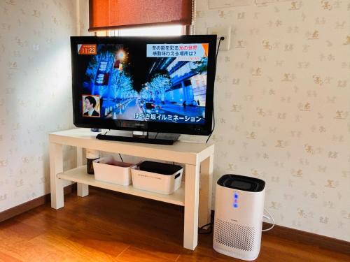 a tv sitting on a white stand with a television at Chiba - House - Vacation STAY 41221v in Chiba