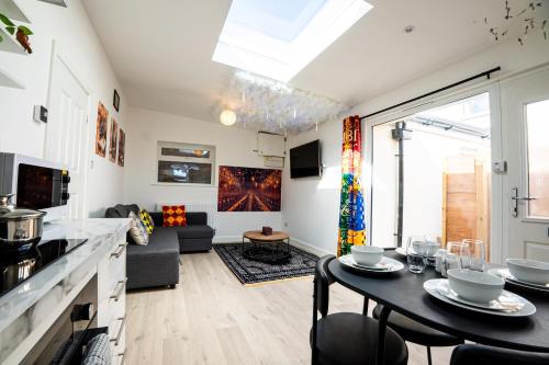 a kitchen and living room with a table and a couch at The Grand Hogwarts Suite A Magical Experience in Leavesden Green