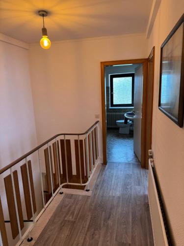 a hallway with a staircase and a stair case at MonteurGut Apartments Kastanie in Marren