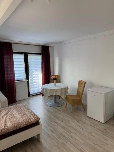 a room with a bed and a table and some windows at MonteurGut Apartments Kastanie in Marren