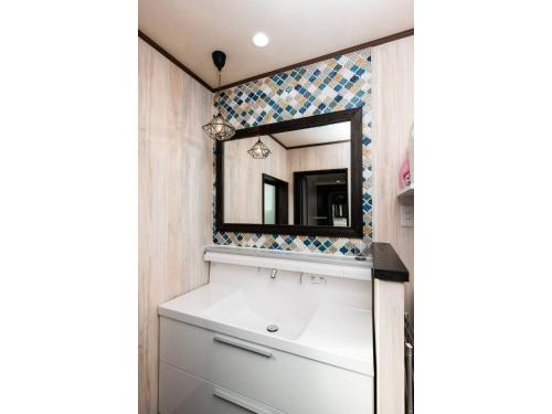 une salle de bains avec un lavabo et un miroir dans l'établissement KOTONONE MAI - Vacation STAY 87621, à Yufu