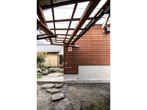 a garage with awning on the side of a house at YUFUIN MEGUMI NO SATO - Vacation STAY 87999 in Yufuin