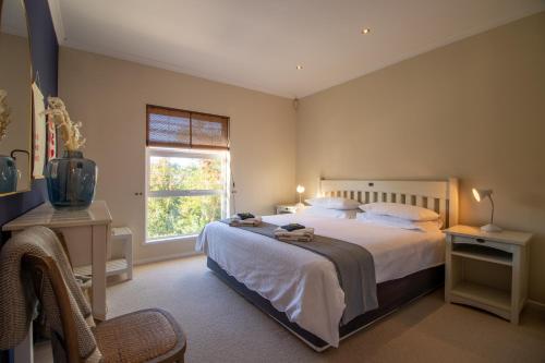 una camera da letto con un letto grande e una finestra di 19 Pachena at Robberg Beach a Plettenberg Bay