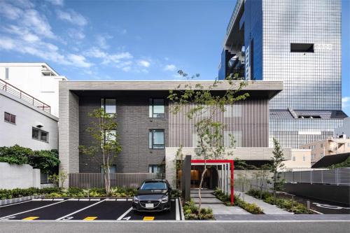 a car parked in a parking lot in front of a building at Rakuten STAY Osaka Station North Deluxe Fourth in Osaka