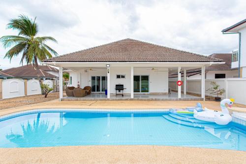 a swimming pool in front of a house at D2 Pool Villa in Hua Hin