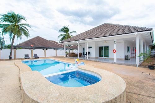 a swimming pool in front of a house at D2 Pool Villa in Hua Hin