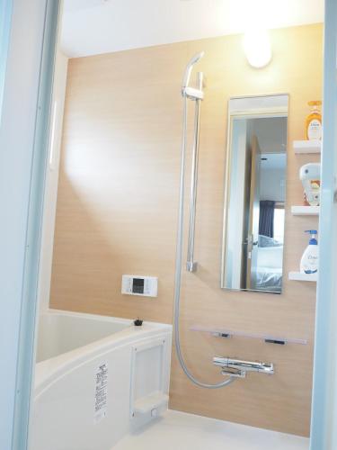 a bathroom with a shower and a tub and a sink at Harbour Inn & Suites - Vacation STAY 8829 in Niigata