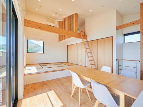 a kitchen and dining room with a wooden table and chairs at Kino-saji - Vacation STAY 89208 in Ibusuki