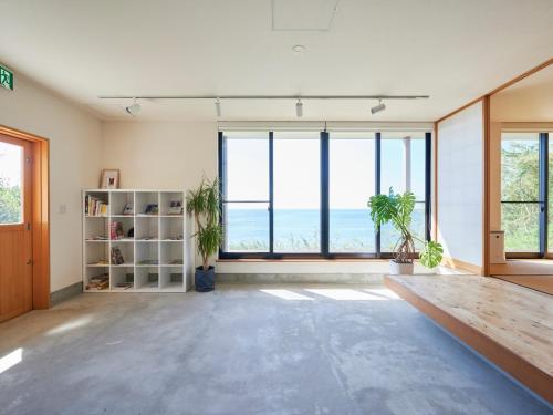 an empty room with large windows and a view of the ocean at Kino-saji - Vacation STAY 89208 in Ibusuki