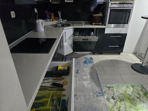 a kitchen being remodeled with an open cabinet in the floor at Holiday & Living House Near Sarajevo in Vogošća