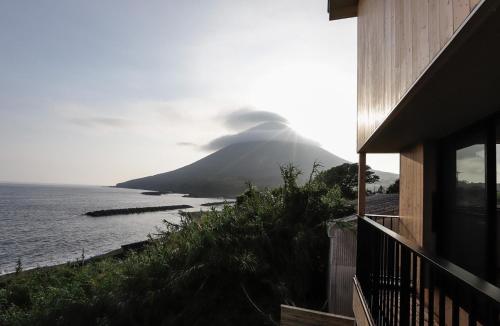 a house with a view of a mountain and the ocean at Kino-saji - Vacation STAY 89208 in Ibusuki