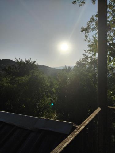 a view of the mountains from the porch of a house at Lusa Guesthouse in Nikortsminda