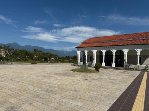 a building with a red roof and a courtyard at Azumi Holiday House in Azumino