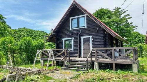 a small wooden house with a porch and a deck at Maniwa - Cottage - Vacation STAY 90022 in Maniwa
