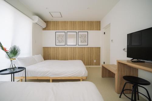 a small room with a bed and a tv at 257-1 - Vacation STAY 91238 in Jima