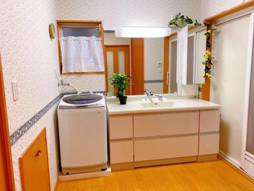 a small bathroom with a sink and a sink at Golf house - Vacation STAY 9043 in Ryūgasaki