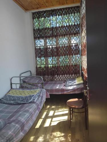 a room with two bunk beds and a chair at Lusa Guesthouse in Nikortsminda