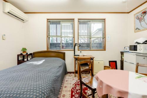 a small bedroom with a bed and a table at Sakai Kita-ku - House - Vacation STAY 10593 in Asakayamachō