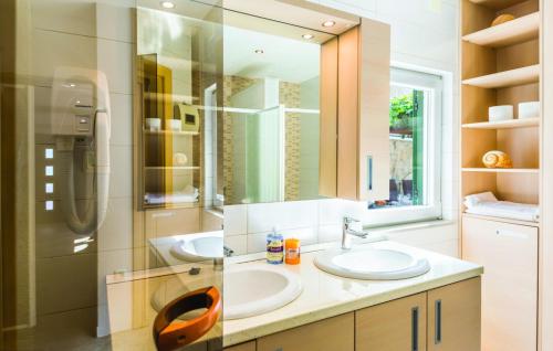 a bathroom with two sinks and a shower and a mirror at Villa Elizabeta Makarska by Villas Guide in Makar