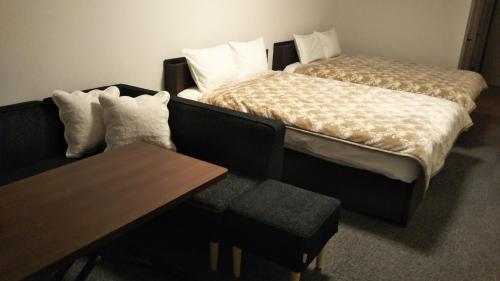 a room with a couch and a bed and a table at KAINOSATO - Vacation STAY 08807v in Azagawa