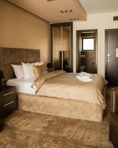 a bedroom with a large bed in a room at Guest House Panorama Aqualux with Free Parking in Novi Sad