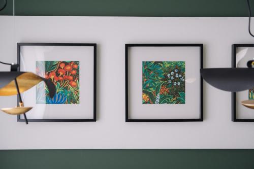 a group of four framed paintings on a white wall at 257-1 - Vacation STAY 91246 in Jima