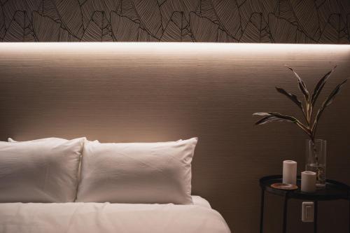 a bedroom with a bed with a white pillow and a plant at 257-1 - Vacation STAY 91246 in Jima