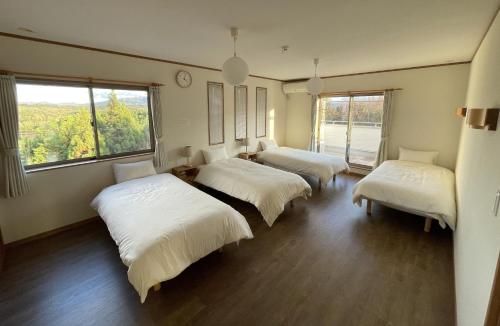 a room with three beds and a large window at Sumoto - House - Vacation STAY 91396 in Sumoto