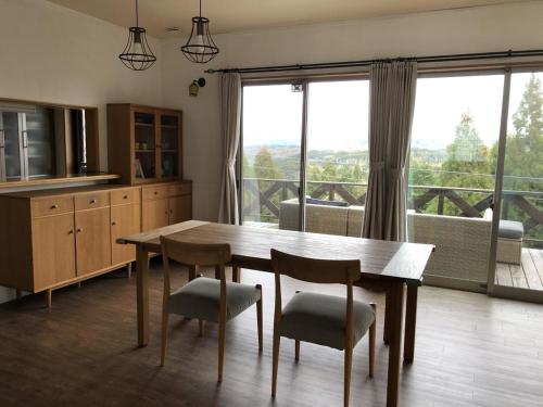 a kitchen with a table and chairs and a large window at Sumoto - House - Vacation STAY 91396 in Sumoto