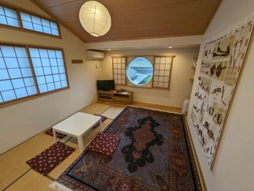 a living room with a table and a rug at guest house Ki-zu - Vacation STAY 92940 in Nishio