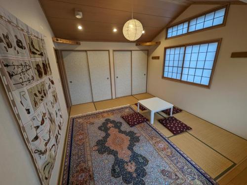 an empty room with a rug and a table at guest house Ki-zu - Vacation STAY 92940 in Nishio