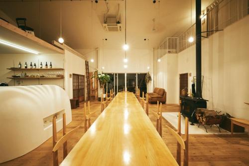 a long wooden table in a large room at Mitoyo - House - Vacation STAY 91451 in Mitoyo
