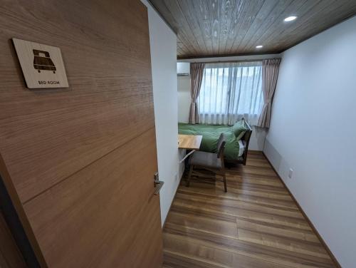 a room with a door and a table and a bed at guest house Ki-zu - Vacation STAY 92940 in Nishio