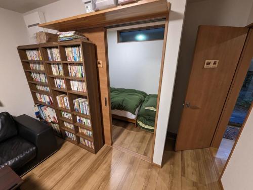 a room with a door open to a room with a book shelf at guest house Ki-zu - Vacation STAY 92940 in Nishio
