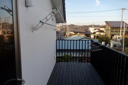 a balcony with a view of a building at guest house Ki-zu - Vacation STAY 92940 in Nishio