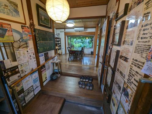 a room with posters on the walls of a restaurant at guest house Ki-zu - Vacation STAY 94978v in Nishio