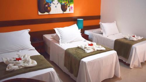 Una cama o camas en una habitación de Pousada Só Alegria