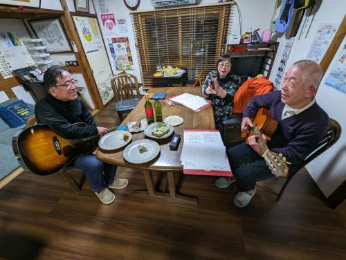 a group of people sitting around a table with instruments at guest house Ki-zu - Vacation STAY 94978v in Nishio