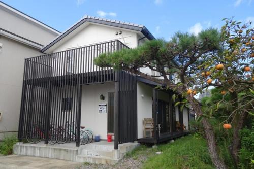 a house with a tree in front of it at guest house Ki-zu - Vacation STAY 94978v in Nishio