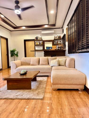 a living room with a couch and a coffee table at Entire Home in Pampanga in San Fernando