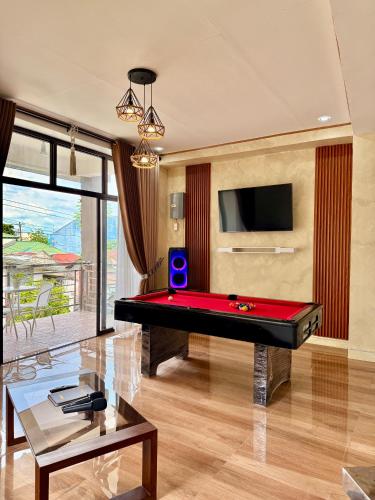 a living room with a pool table and a tv at Entire Home in Pampanga in San Fernando