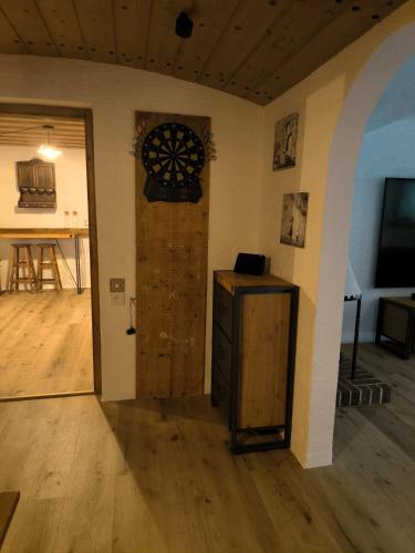 a room with a door and a dart board on the wall at Haus Blindauer Eck in Reit im Winkl
