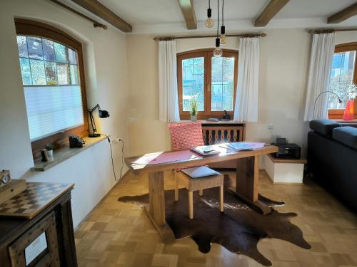 a living room with a wooden table and a couch at Haus Blindauer Eck in Reit im Winkl