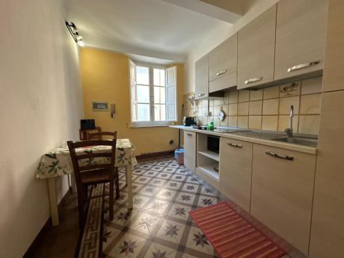 a kitchen with a table and a sink and a counter at Bilocale economico, in pieno centro a Lucca in Lucca