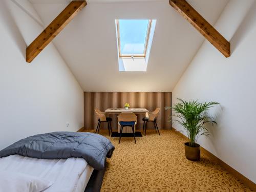 a bedroom with a bed and a table and chairs at The Old Townhouse II in Krosno