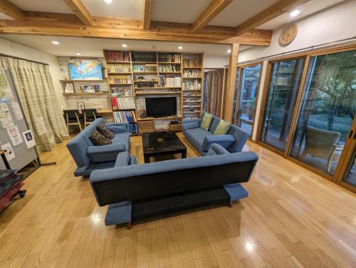 a living room with a couch and chairs and a fireplace at guest house Ki-zu - Vacation STAY 95389v in Nishio