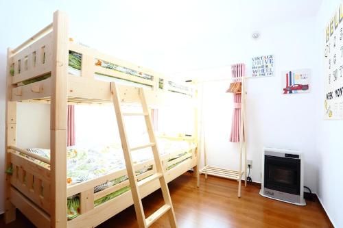 a bedroom with two bunk beds and a tv at Sun River Annex Inaho - Vacation STAY 95961 in Kita-hamachō