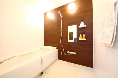 a bathroom with a shower with a toilet and a sink at Sun River Annex Inaho - Vacation STAY 95961 in Kita-hamachō