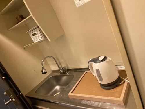 a small kitchen with a sink and a coffee pot at Sudomari Akariya - Vacation STAY 68896v in Tanabe