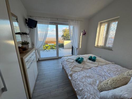 a bedroom with a bed and a view of a patio at Villa ISA 4 bedrooms, 4 bathrooms, sauna, jacuzzi, panoramic view in Vrh
